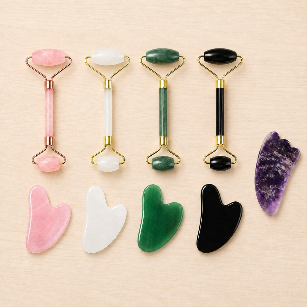 Four facial rollers, four heart-shaped gua sha tools and one Amethyst Horn laid out together